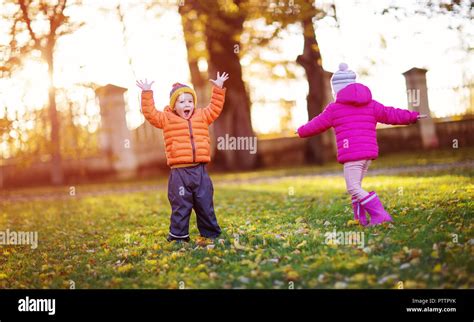 Children throwing autumn leaves hi-res stock photography and images - Alamy