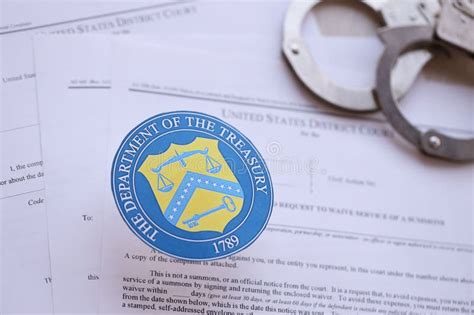 KYIV, UKRAINE - MARCH 9, 2024 US the Department of the Treasury Seal with Handcuffs on Many US ...