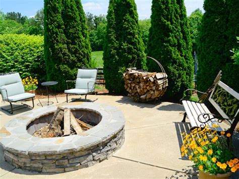 circle up stacked stone enhances this circular fire pit with a flagstone top on a farm in ...