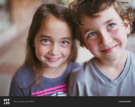 Portrait of smiling fraternal twins stock photo - OFFSET