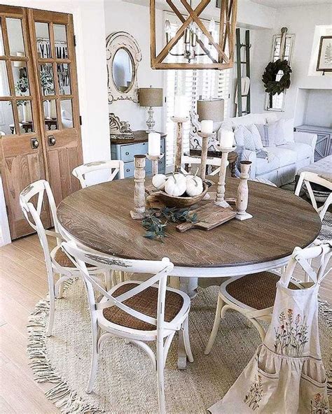 a dining room table with white chairs around it