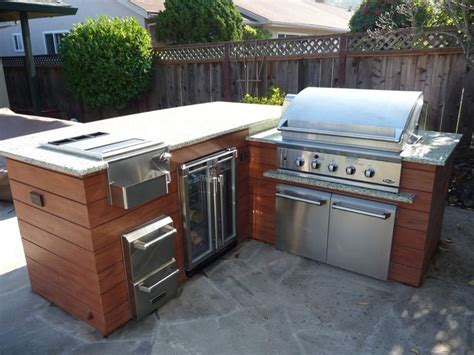 an outdoor kitchen with stainless steel appliances