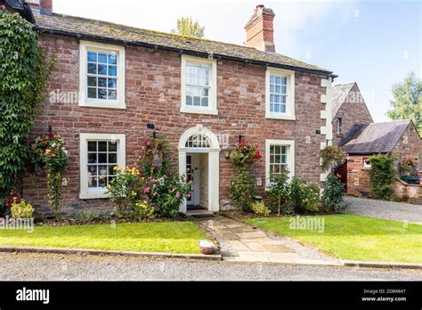 A 19th century house of red sandstone (once a hotel) at the southern end of Old Lanercost Bridge ...