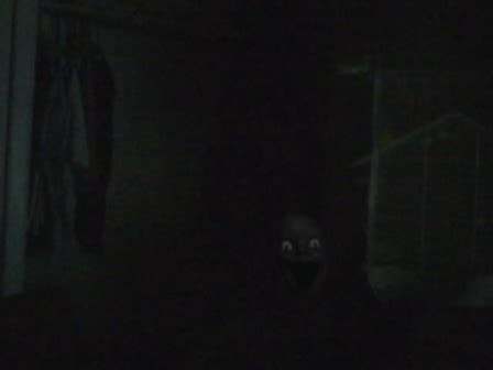 a dark room with the light on and a creepy face in the middle of it