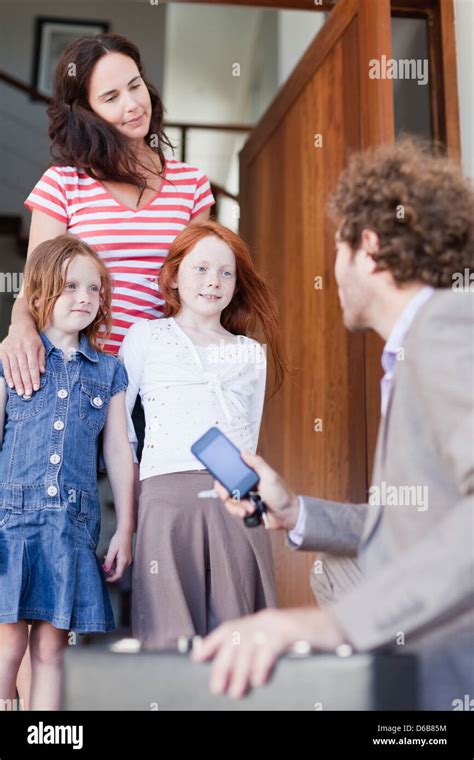 Businessman saying goodbye to family Stock Photo - Alamy