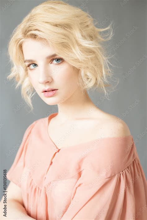 Young blonde woman with blue eyes. Portrait of a beautiful blonde girl. Fashion model. Woman ...