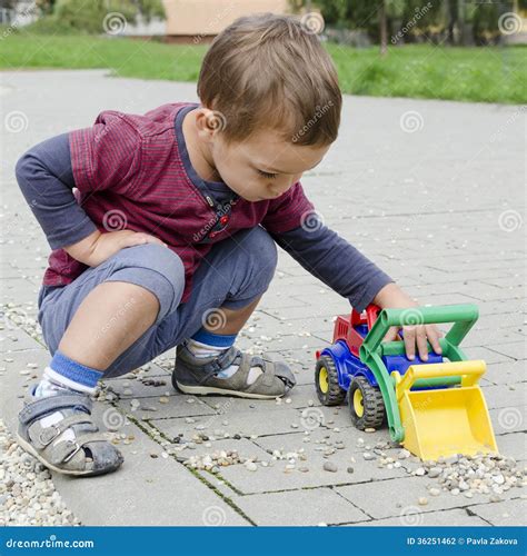 Child playing with toy car stock photo. Image of outside - 36251462