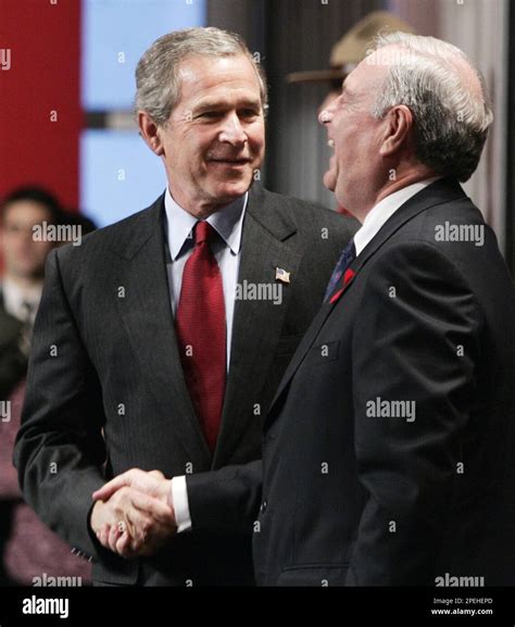 Canadian Prime Minister Paul Martin, right, laughs heartily as he shakes hands with U.S ...