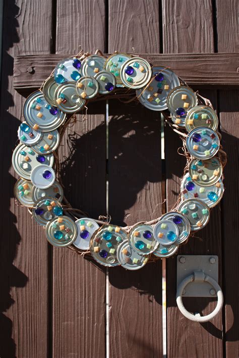 wreath for our courtyard doors for in-between the holidays -glued tin can lids to a grapevine ...