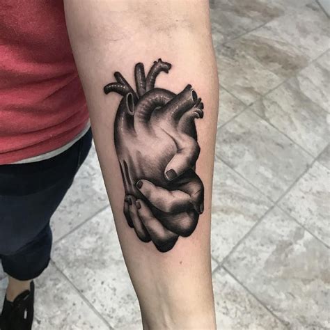 Black and grey realism anatomical heart with holding hands tattoo - peace, love, by Aaron Carey ...