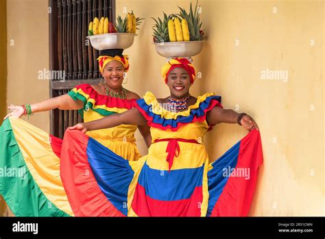 Happy, smiling Palenquera fresh fruit street vendors in the Old Town of Cartagena, Colombia ...