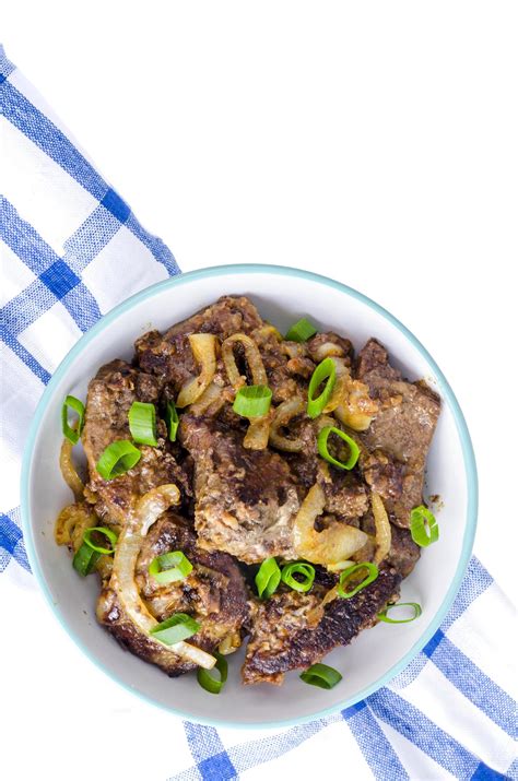 Fried liver with onions in bowl on white background. 5432221 Stock Photo at Vecteezy