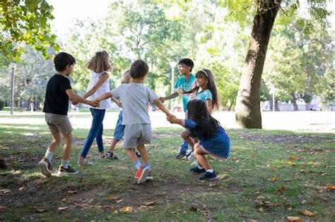 Free Photo | Happy children playing together outdoors, dancing around ...