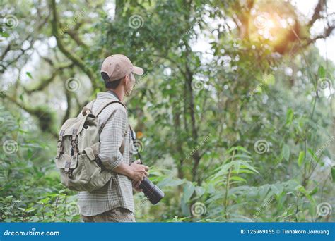 Thoughtful Young Man Using Camera while Hiking in Nature, Hiking Stock Image - Image of ...