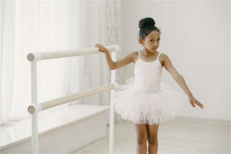 Free Photo | Cute little ballerina in pink ballet costume. Child in a pointe shoes is dancing in ...