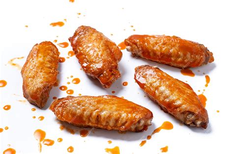 Premium Photo | Buffalo spicy chicken wings with cayenne pepper sauce isolated on white background