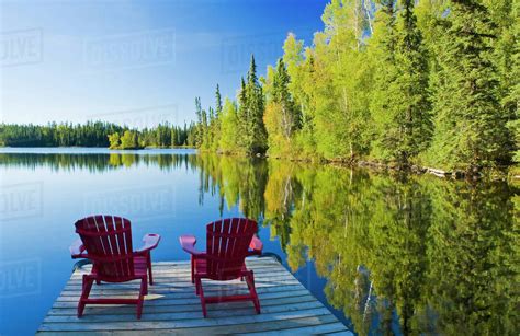 Adirondack chairs, MacKay Lake, northern Saskatchewan, Canada - Stock ...