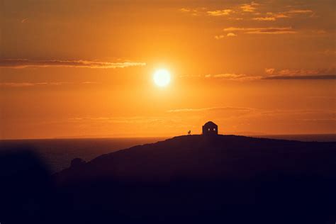 Silhouette of a Building on a Hill at Sunset · Free Stock Photo