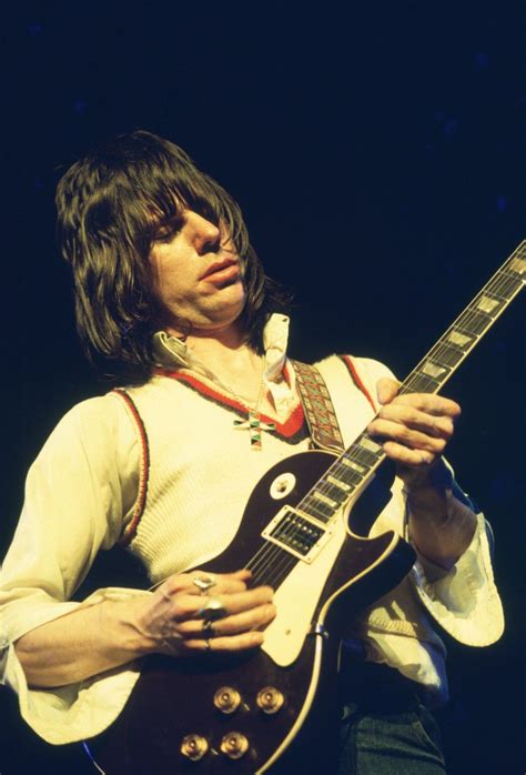 a man playing an electric guitar on stage