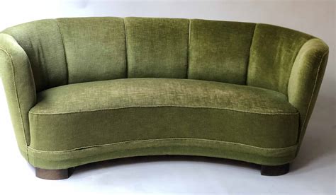 ART DECO STYLE SOFA, of curved form with green velvet corded upholstery ...