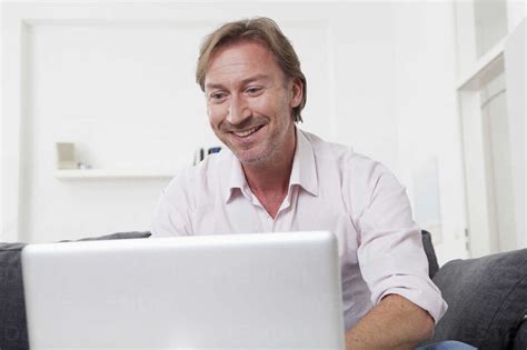 Man using laptop, smiling stock photo