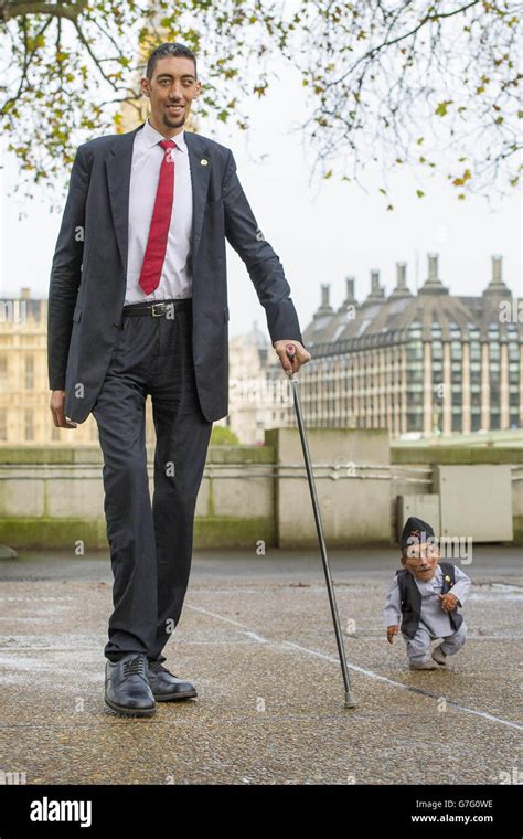 Chandra Dangi, who is 21.5 inches tall, with Sultan Kosen, who is 8 feet 3 inches tall, at a ...