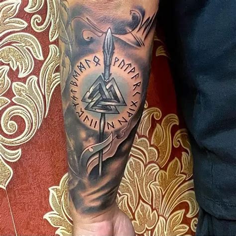 a man's arm with a compass tattoo on it and an all seeing triangle