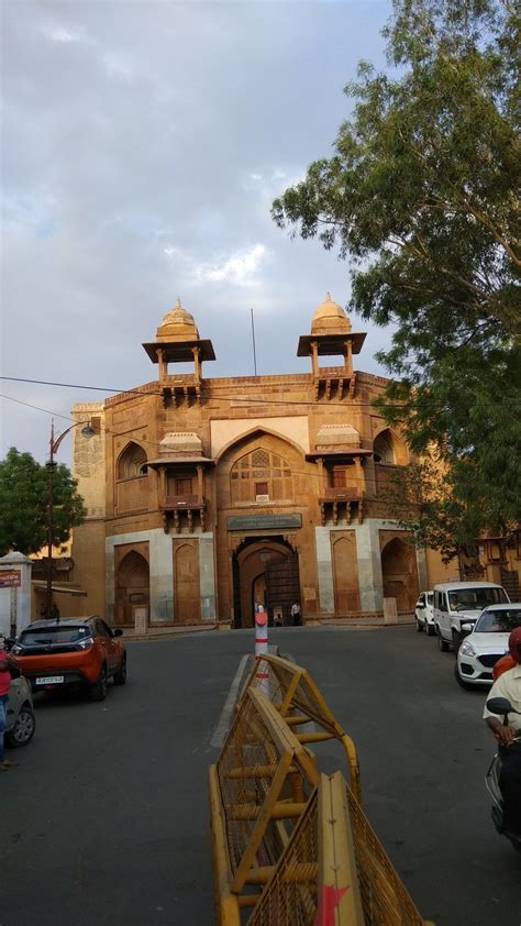 an old building with cars parked in front