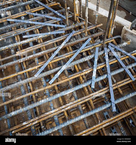 Reinforcement bars and punching shear rails of an RC slab in a construction site. Squared format ...