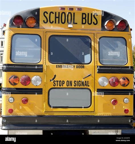 Rear view of a traditional yellow school bus on the street Stock Photo - Alamy