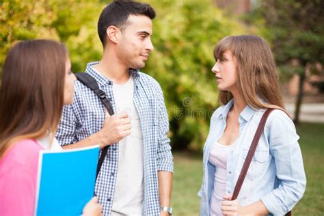 Friends talking in a park stock photo. Image of green - 50879876