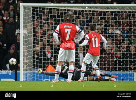 London, UK. 26th Nov, 2013. Marseille's Steve Mandanda saves a penalty from Arsenal's Mesut Ozil ...