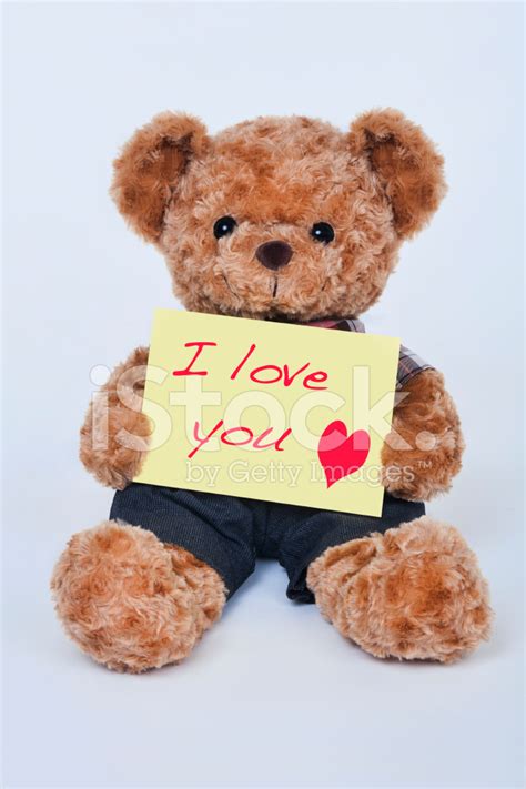 Teddy Bear Holding A Yellow Sign Saying I Love You stock photos - FreeImages.com