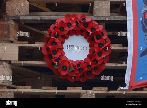 A Royal British Legion poppy wreath is hung on a large bonfire being built to mark the Catholic ...