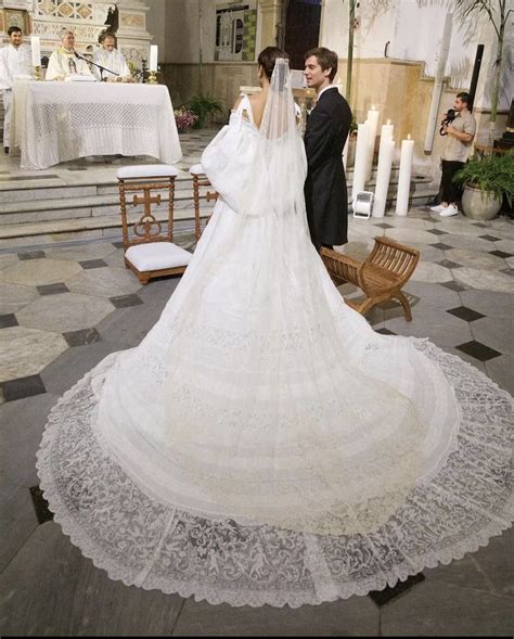 a bride and groom standing in front of the alter