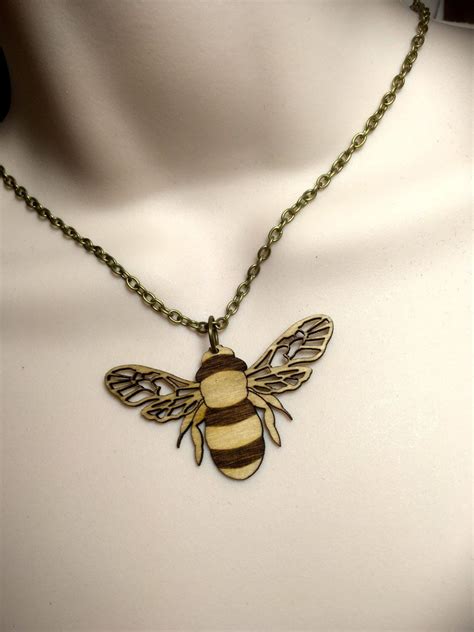 Laser cut Birch wood 'BEE' necklace by RichardsonRichardson on Etsy https://www.etsy.com/listing ...