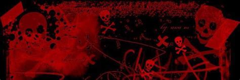 red and black graffiti on the side of a building with skulls, bones and crossbones