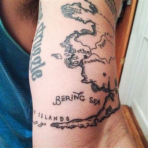 Simple homemade like black ink arm tattoo of world map part - Tattooimages.biz