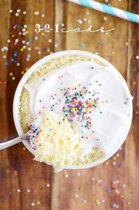 a cup filled with frosting and sprinkles on top of a wooden table