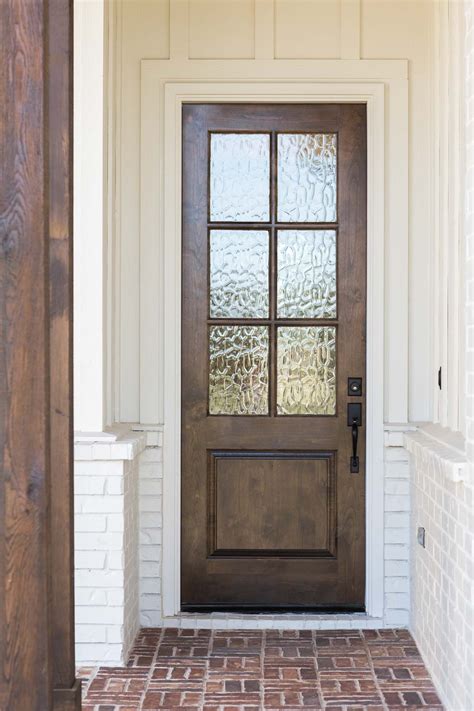 Wood door with glass entryway against white exterior walls. Modern farmhouse style. | Wood ...