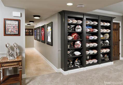 Black shelves show off football memorabilia | Man cave basement decor ...