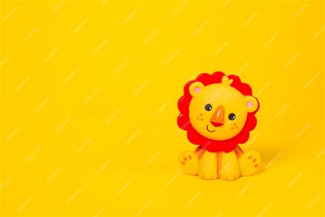Premium Photo | Baby toy lion made of plastic on a yellow background with copy space Cute ...