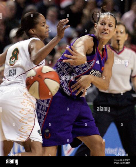 Sacramento Monarchs' Ticha Penicheiro, right, gets a pass past Seattle Storm's Kimberly Beck in ...