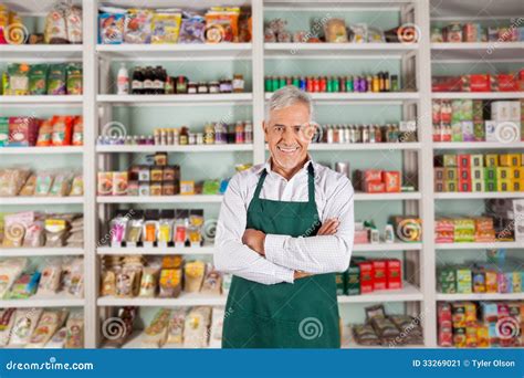 Senior Male Owner Standing In Supermarket Stock Image - Image: 33269021