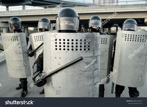 Group Riot Police Helmets Hitting Shields Stock Photo 2006282483 | Shutterstock