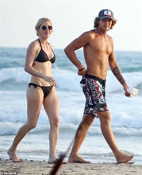 Ellie Goulding's romance with hunky surfing instructor heats up! Singer looks cosy with Armando ...