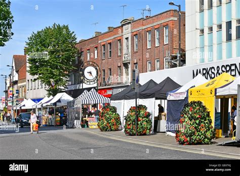 English town centre shopping High Street businesses with market stalls outside Marks and Spencer ...