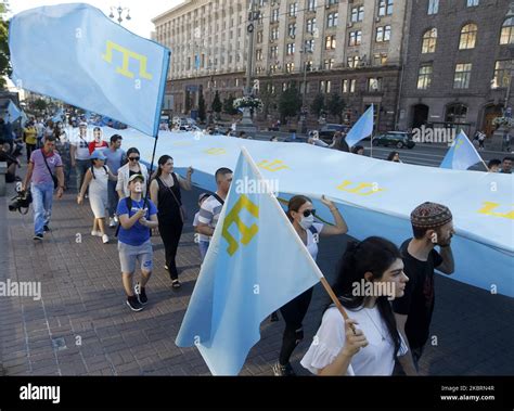 Crimean Tatars community in Ukraine carries a giant Crimean Tatar flag at a rally to the Crimean ...