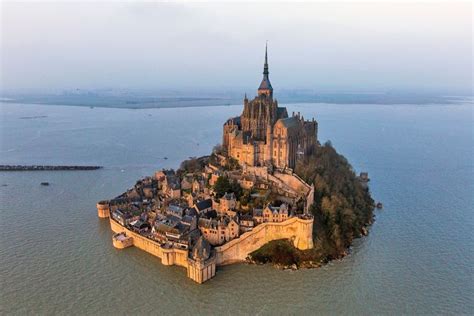 Stone castle on the oasis of Mont Saint-Michel, France | World heritage sites, Wonders of the ...