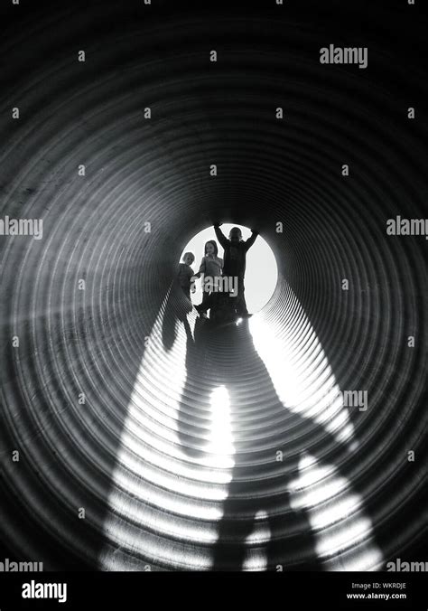 Children Playing In Tunnel Slide At Playground Stock Photo - Alamy